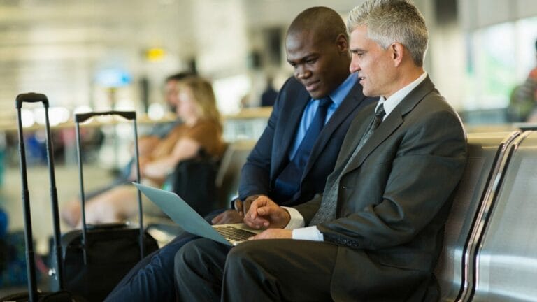 men using a laptop for unified communication benefits